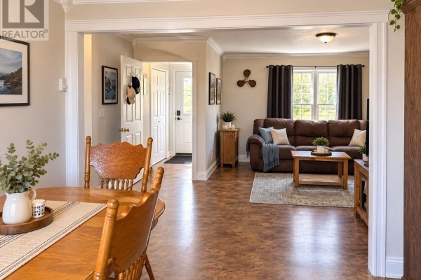 View from the dining area towards the open-concept living room and entrance hallway with white doors. - 86a Main Road, Piccadilly