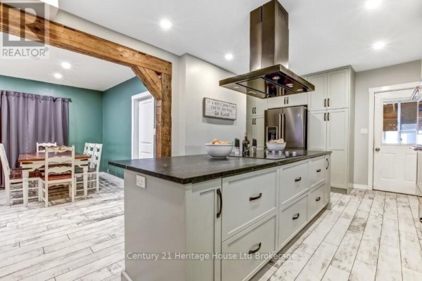 Kitchen view showing farmhouse sink, subway tile backsplash, and stainless steel dishwasher - 87 Bay Street, Woodstock
