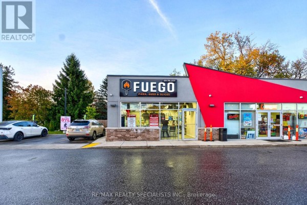 Front entrance of Fuego with signage and open hours displayed - 87 Garafraxa Street, Chatsworth