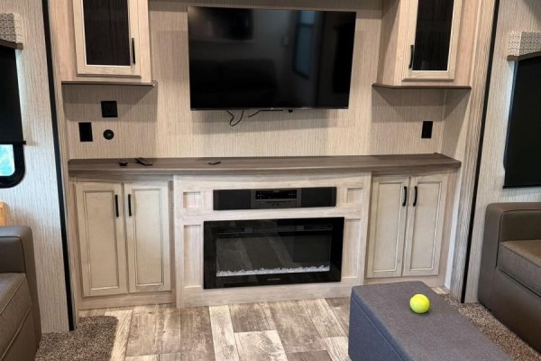 Close-up of the living room fireplace with integrated soundbar and television above. - 87 Maplesue Point Drive, Molega Mines