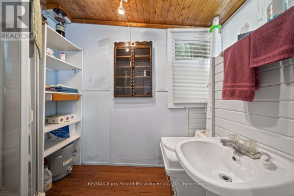 Bathroom with sink, toilet, and storage shelves - 87 Millies Road Seguin