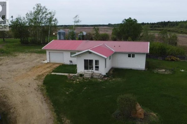 Aerial view of the property showing the house, outbuildings, fields, and a pond. - 872068 Range Road 235, Rural Northern Lights, County Of