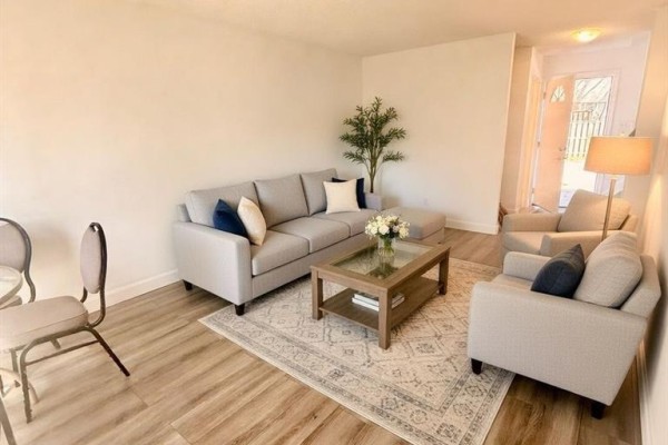 Living room with a sectional sofa, two armchairs, coffee table, and a view of the entryway. - 873 Southdale Road E, London South