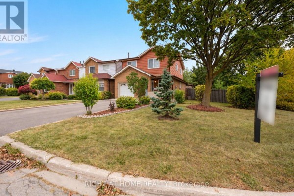 Exterior view of a suburban street with residential houses and manicured lawns. - 875 Messenger Meadow Drive, Mississauga