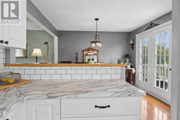 Marble countertop kitchen with subway tile backsplash and double doors - 876 Hillsview Street Renfrew