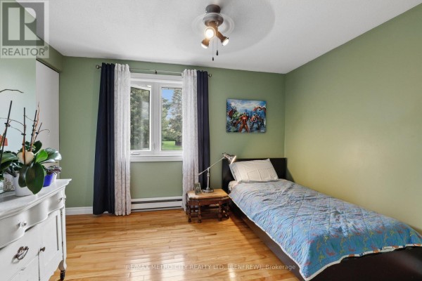 Bedroom with Avengers art, single bed, and dresser - 876 Hillsview Street Renfrew