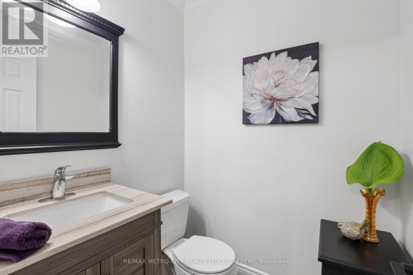 Modern bathroom vanity, toilet, and mirror - 876 Hillsview Street Renfrew