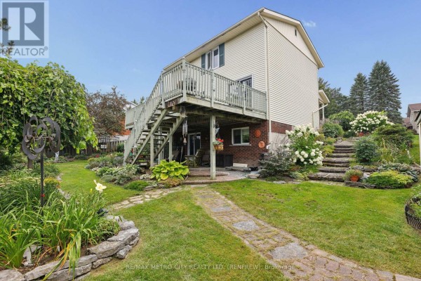 Backyard with deck and stone stairs - 876 Hillsview Street Renfrew