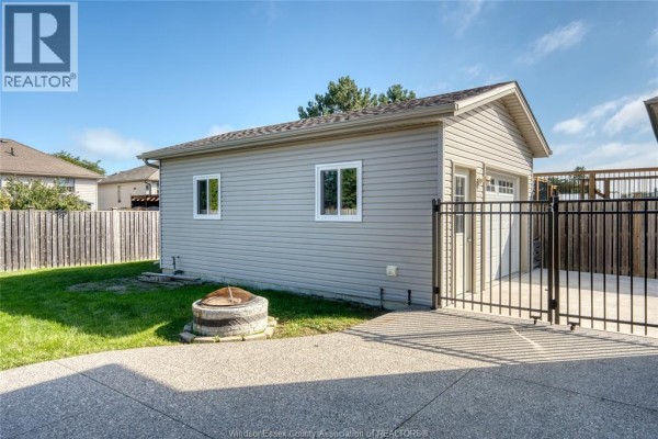 Entrance hall with tiled floor, white staircase with metal railing, and mirrored closet doors. - 879 Westwood, Lakeshore
