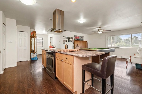 Open concept kitchen and living area with a pool table, island, and large windows. - 8792 Bellevue Drive, Chilliwack Proper West, Chilliwack