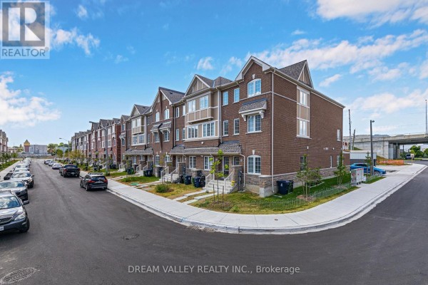 A panoramic view of a street lined with brick townhouses and parked cars. - 88 Jolly Way S, Toronto