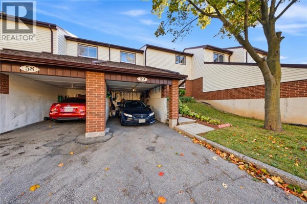 Side view of townhouse exterior with two covered carports, unit numbers 58 and 59 visible. - 880 Limeridge Road E Unit# 59, Hamilton