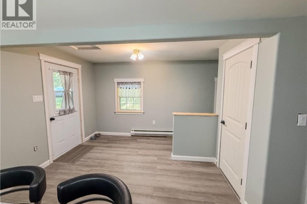 Interior living area with light gray walls, wood-look flooring, and white trim. - 883 Route 855, Midland