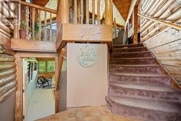 Bathroom with a toilet, bathtub with shower curtain, and wood floors. - 8896 Highway 224, Greenwood