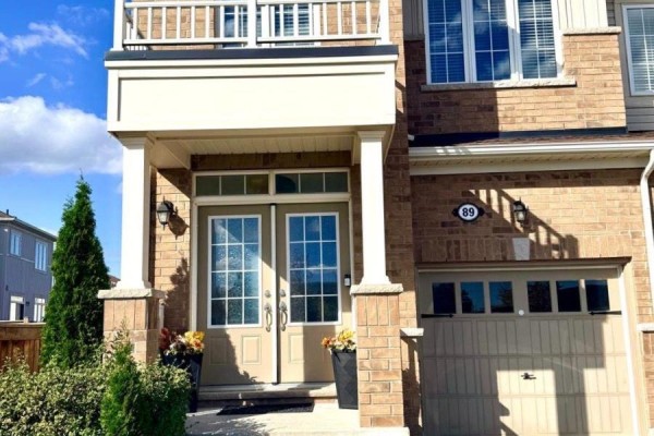 Close-up of the double front doors and garage of a brick townhouse. - 89 Hartley Avenue, Brant