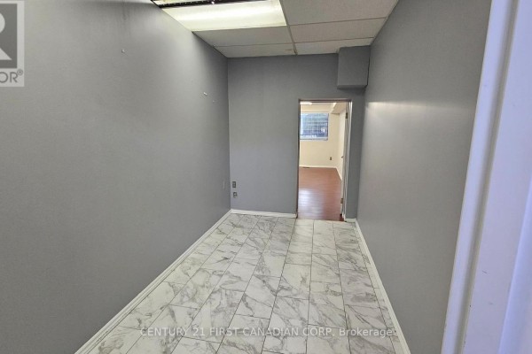 Empty room with grey walls and marbled tile flooring, open doorway. - 89 Wharncliffe Road N, London North
