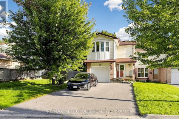 Front exterior of a residential house with beige siding and brick accents. - 892 Gentry Crescent, Oshawa