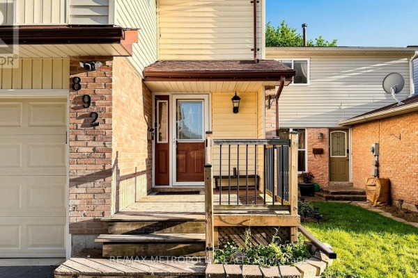 Close-up of the front porch entrance with wooden steps and a dark railing. - 892 Gentry Crescent, Oshawa