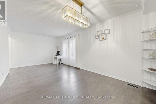 Interior view of a bright living room with white walls and light wood flooring. - 892 Gentry Crescent, Oshawa