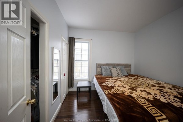 Bedroom with bed, closet, and window - 894 University Avenue Windsor