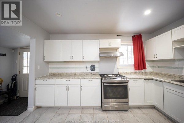 Kitchen with white cabinets, granite countertops, gas range - 894 University Avenue Windsor