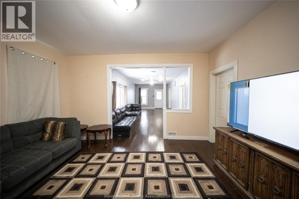Living room with sectional sofa, geometric rug, and TV - 894 University Avenue Windsor