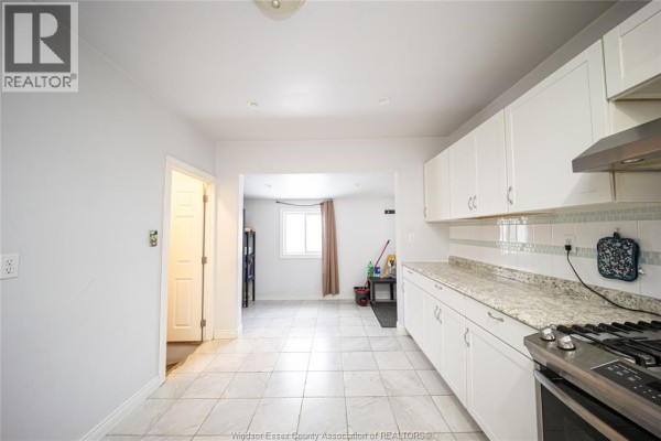 Kitchen with white cabinets, granite counters, gas range - 894 University Avenue Windsor