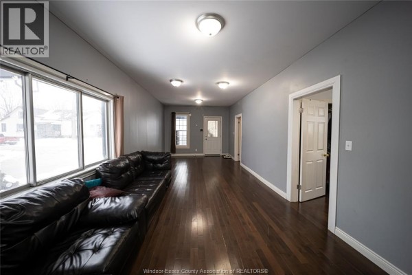 Living room with sectional sofa and hardwood floors - 894 University Avenue Windsor