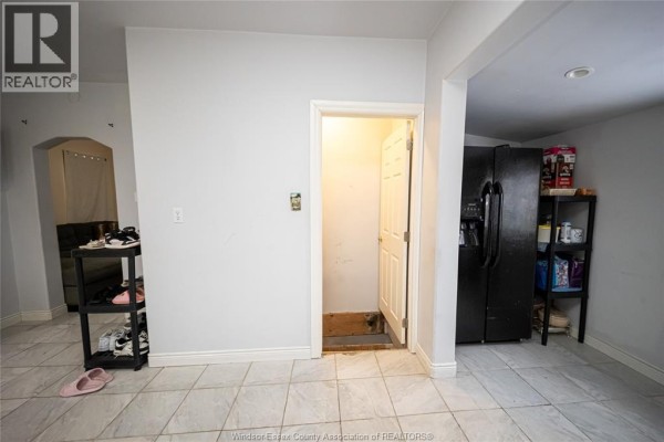 Black refrigerator and tile flooring - 894 University Avenue Windsor