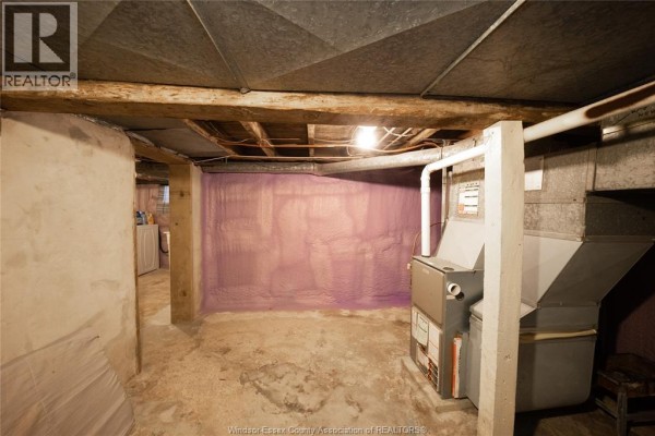 Basement with furnace, water heater, ductwork, laundry machine and purple spray foam insulation - 894 University Avenue Windsor