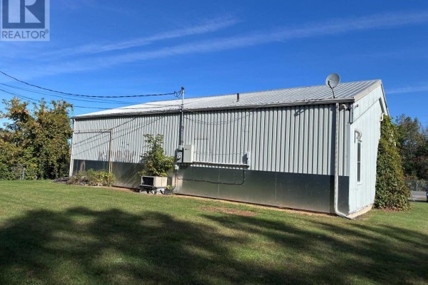 Rear exterior view of a commercial building with corrugated metal siding and a pitched metal roof. - 896 Cecile Boulevard, Hawkesbury