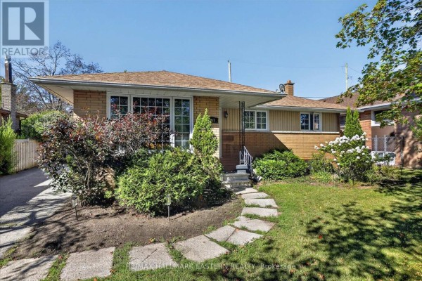 Front view of the house with snow and landscaped shrubs - 897 Westdale Avenue, Peterborough