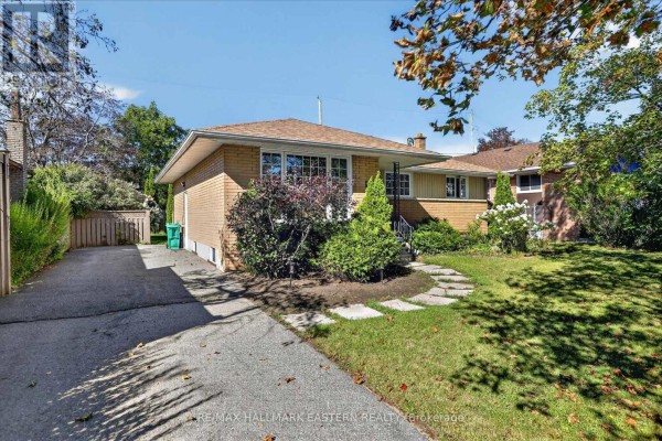 Side view of the bungalow with snow and trees - 897 Westdale Avenue, Peterborough