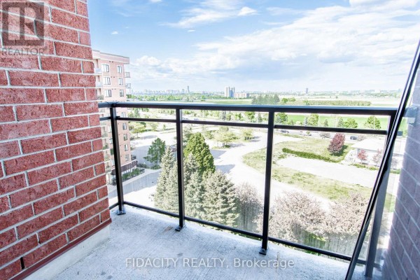 Balcony view from a brick apartment building, overlooking trees and a distant city skyline. - 8a - 310 Central Park Drive, Ottawa
