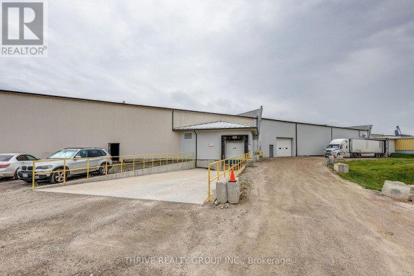 Loading dock area with ramp and clear access to the warehouse. - 8a - 516 John Street N, Aylmer