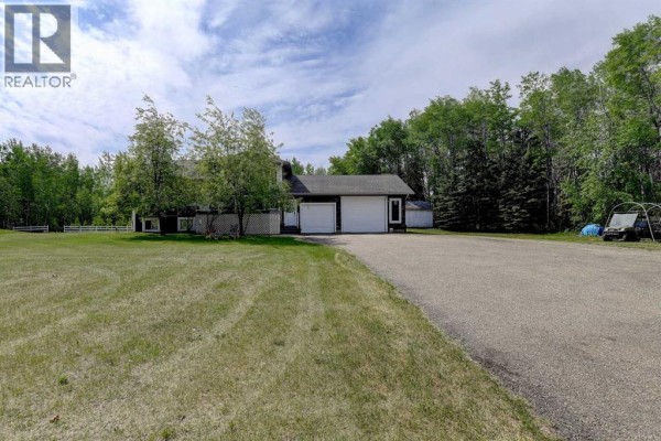 Living area with leather sofa, wooden desk, built-in cabinet, and hardwood floors. - 9, 712051 Range Road 54, Rural Grande Prairie No  1, County Of