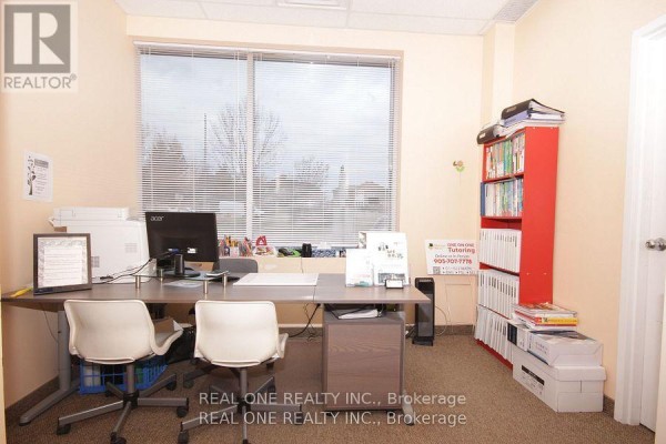 Office space with a desk, computer, chairs, window, and a red bookshelf - #9 - 1455 Sixteenth Avenue, Richmond Hill