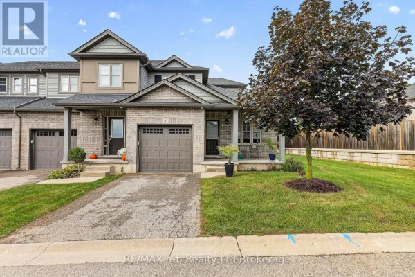 Front exterior of a townhouse with a garage and covered porch. - 9 - 175 Ingersoll Street N, Ingersoll