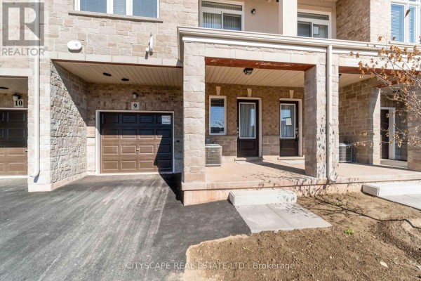 Close-up of townhouse entrance with a garage door labeled 9 and two front doors. - 9 - 40 Zinfandel Drive, Hamilton
