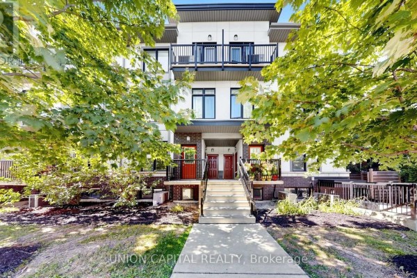 Exterior view of a townhouse complex with multiple units and landscaped front yards. - 9 - 6 Bicknell Avenue, Toronto