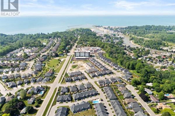 Aerial view showcasing a wide sandy beach, a harbor with a breakwall, and the expansive blue water of Lake Erie. - 9 - 62 Compass Trail, Central Elgin