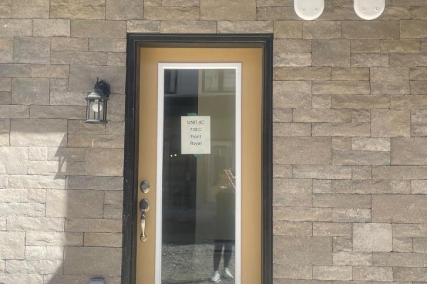 Close-up of a tan-colored front door with a glass panel, mounted on a stone facade. - 9 - 726 Front Royal Street, Mississauga