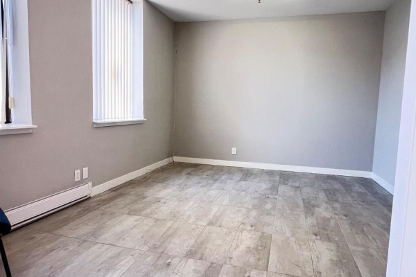 Empty office room with light grey walls, beige tile floor, and large window with blinds. - 9 & 10 - 6731 Columbus Road, Mississauga