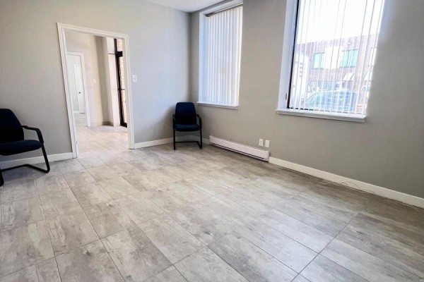 Office space with light grey walls, beige tile floor, windows, and chairs. - 9 & 10 - 6731 Columbus Road, Mississauga