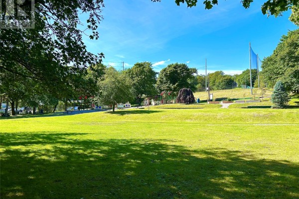 Sunny park with a large lawn, trees, and a playground in the distance. - 9-11 Angel Place, St  John S