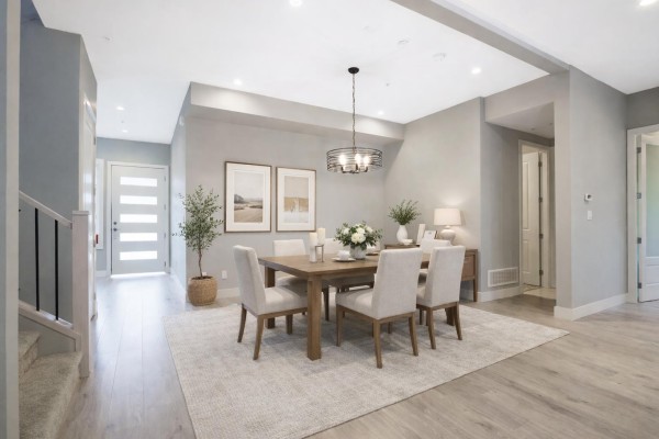 Dining room with a wooden table and chairs, neutral rug, buffet, and a view of the entryway and stairs. - 9 7138 Marble Hill Road, Eastern Hillsides, Chilliwack