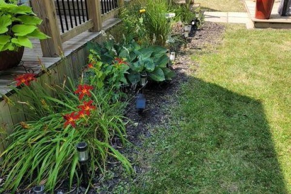 Wooden deck leading to backyard with adjacent house visible - 9 Beech Street, Port Colborne