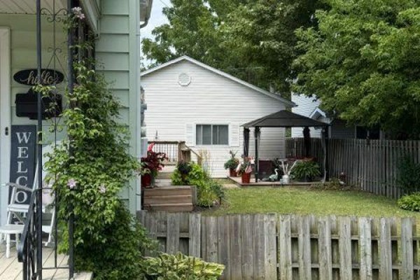 Side view of house showing deck and yard with trees - 9 Beech Street, Port Colborne