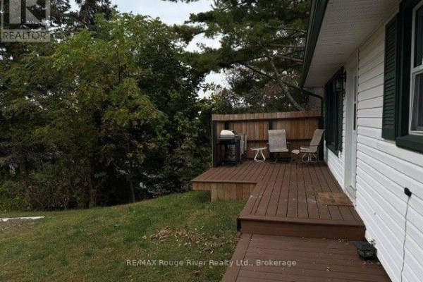 Close-up of the deck with seating and grill, surrounded by snow. - 9 Cedar Street, Cramahe