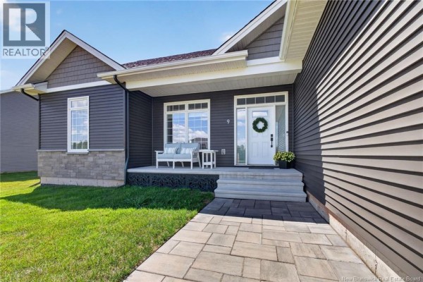 Close-up view of the covered front porch with seating and a white front door. - 9 Congressional Crescent, Moncton
